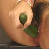 Teen plugs a huge cucumber in pussy